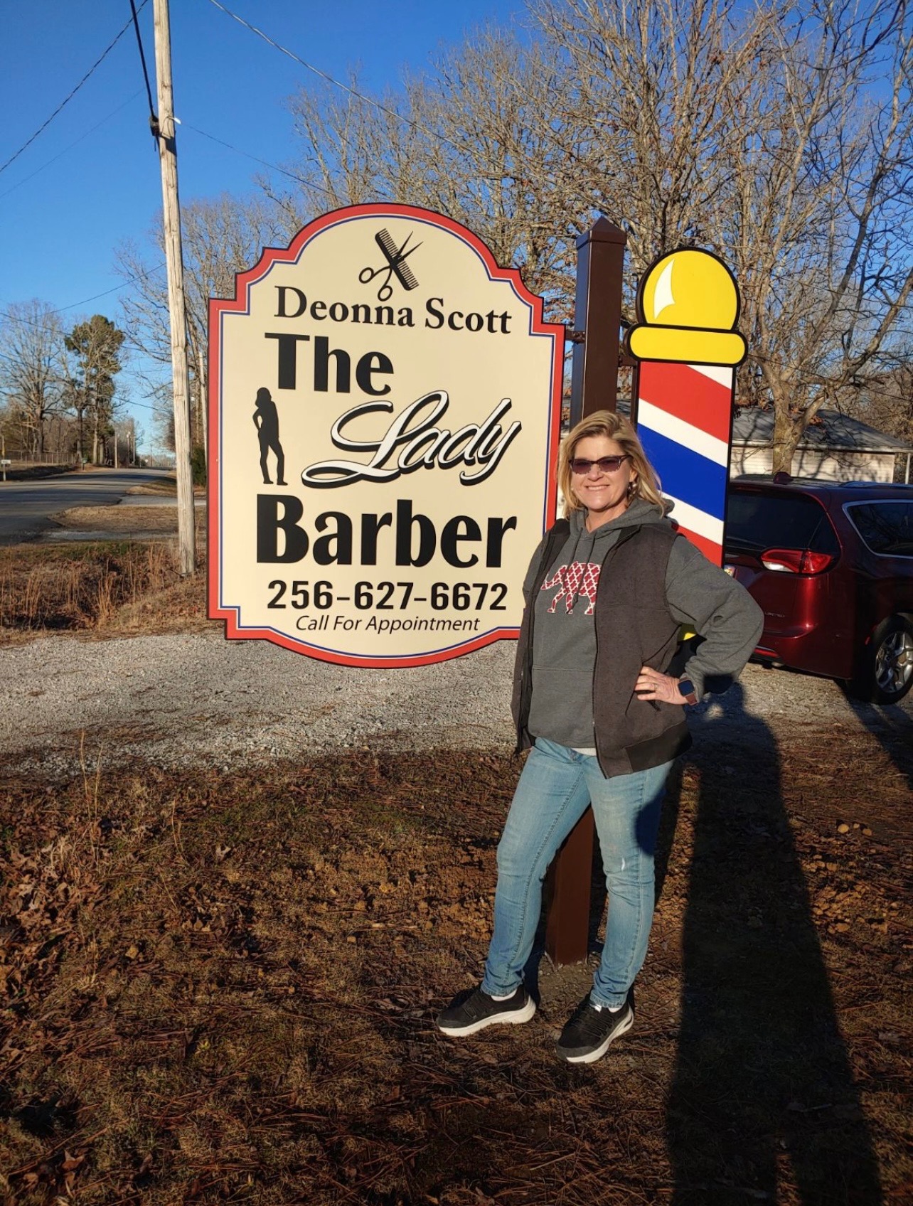 Deonna w/ Business Sign